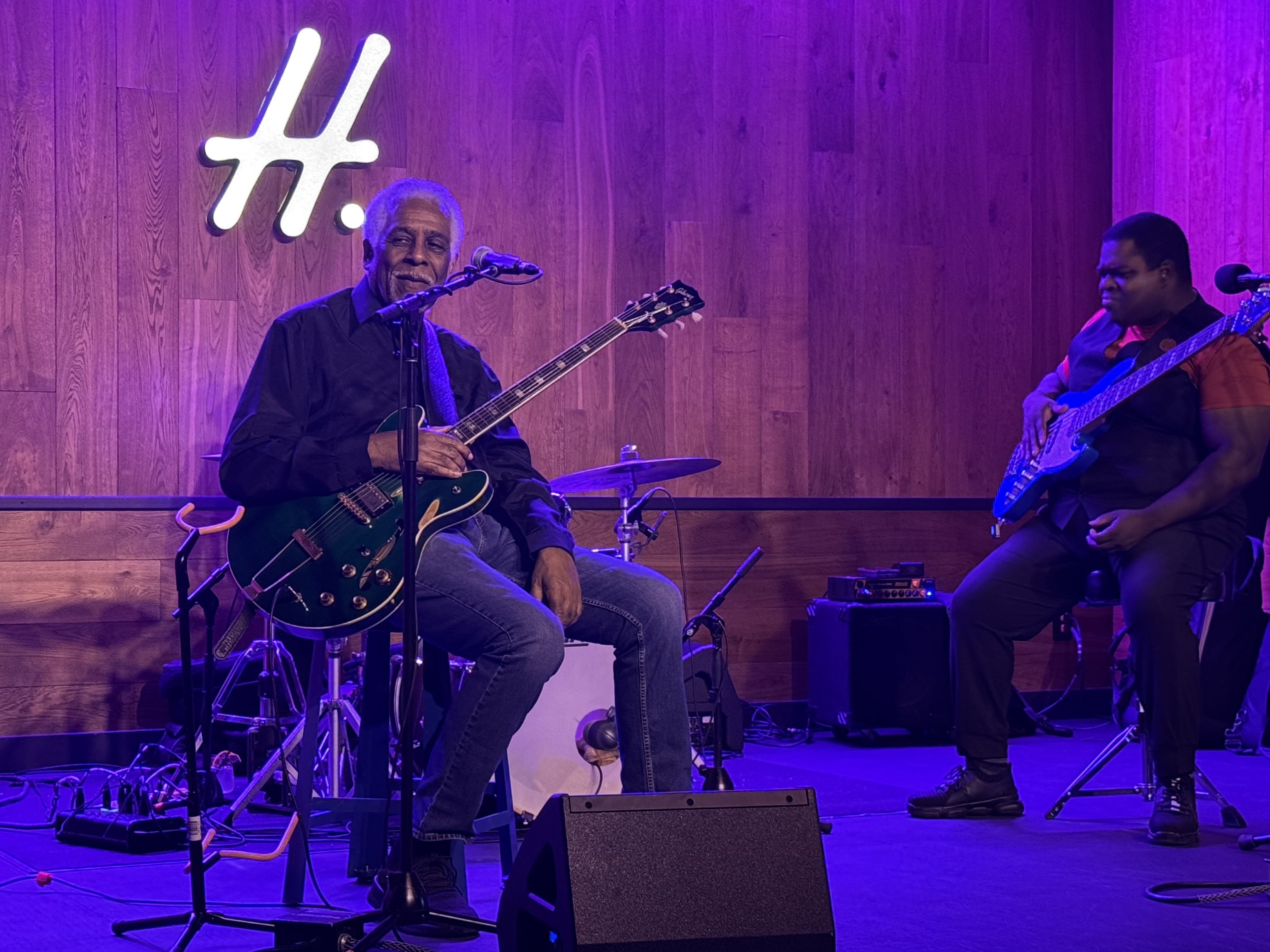 Leroy Emmanuel smiling while performing with LMT Connection at Helliwell Hall