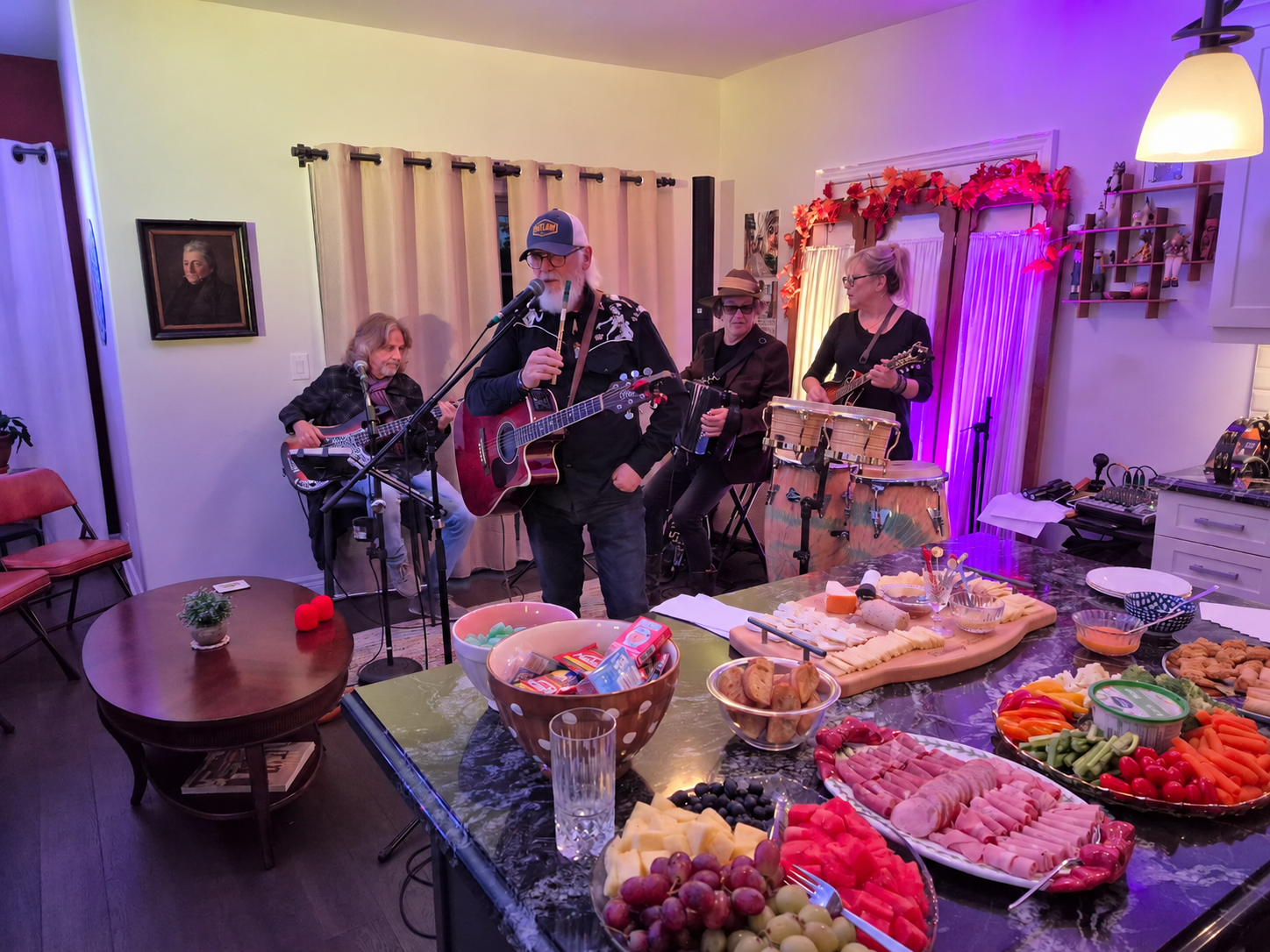 Marty Hopkins and his fellow musicians sound check in Bob and Carol's dining room, with some of the evening's refreshments in the foreground