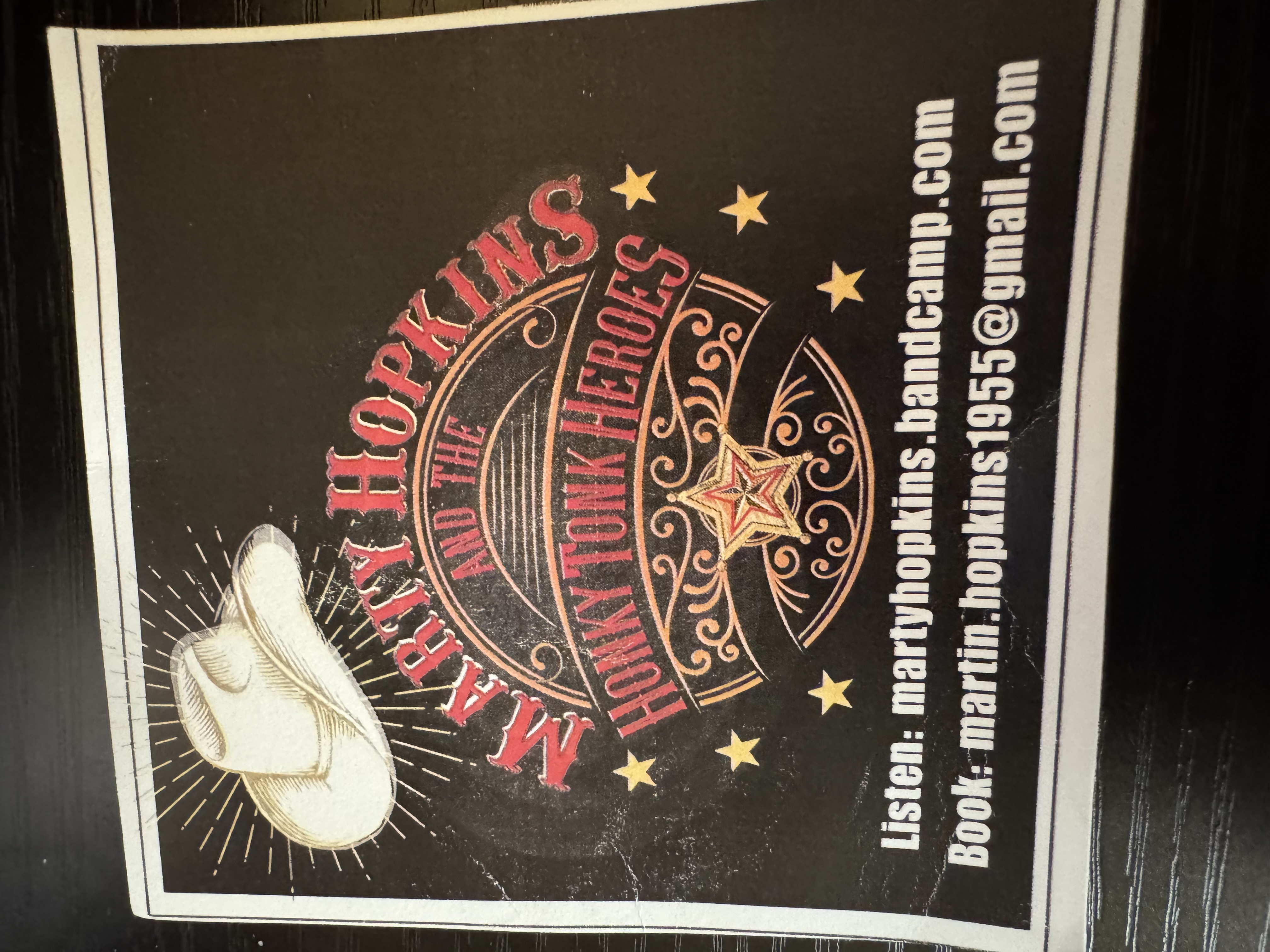 Marty Hopkins' promotional card, featuring his Honky Tonk Heroes artwork and music information.